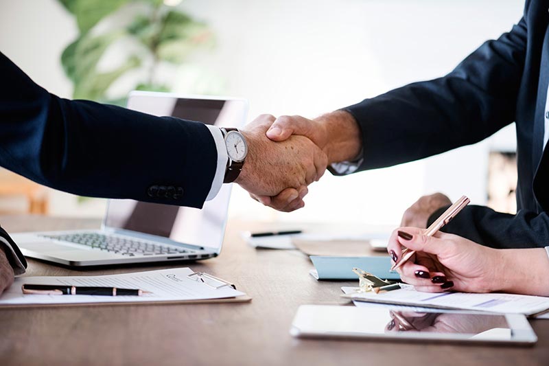 two loan officers shaking hands